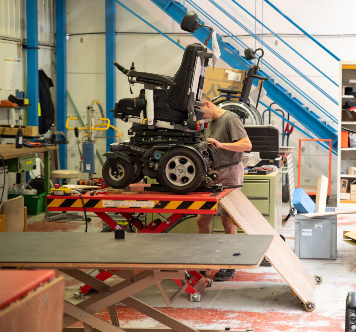 VIGO-medewerker werkt aan rolstoel in de technische dienst
